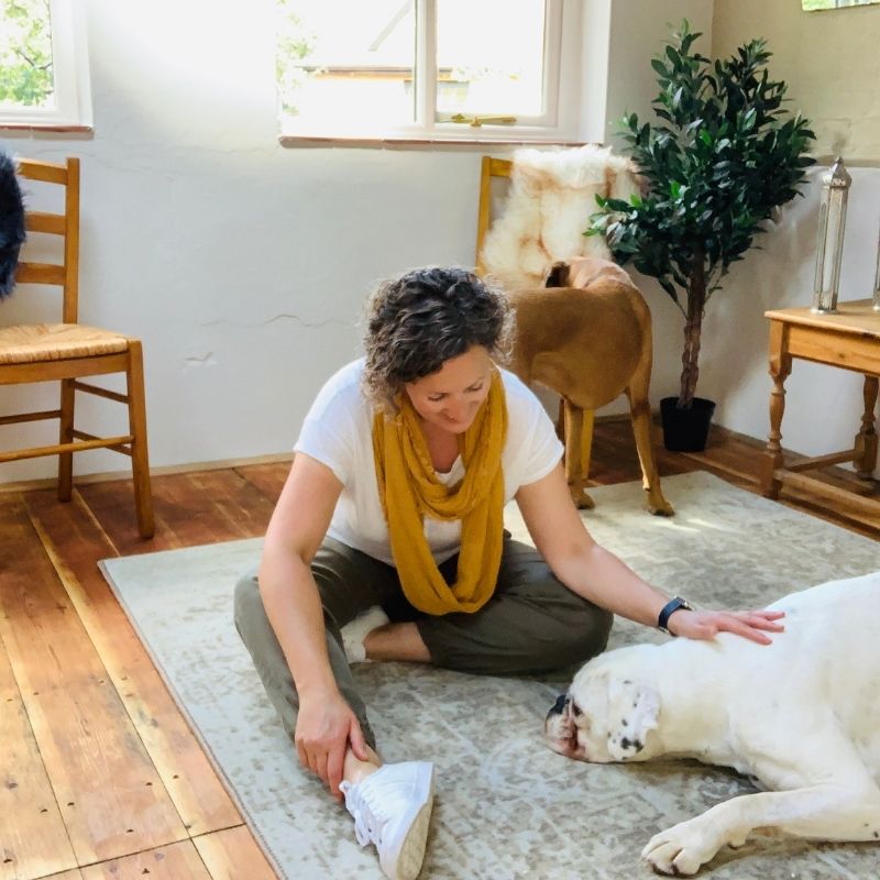 A picture of Ali with her two dogs